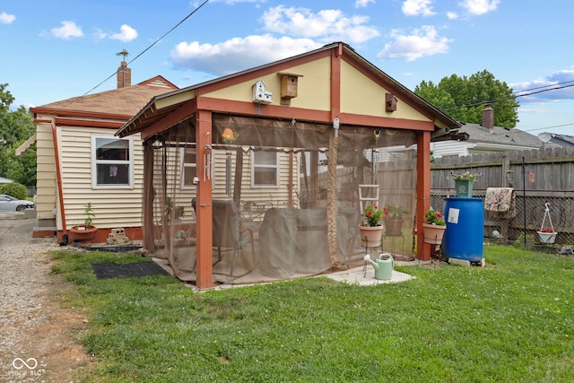 2017 E Legrande Ave, Indianapolis, IN 46203 - rear view of house with a sunroom, a chimney, and a shingled roof
