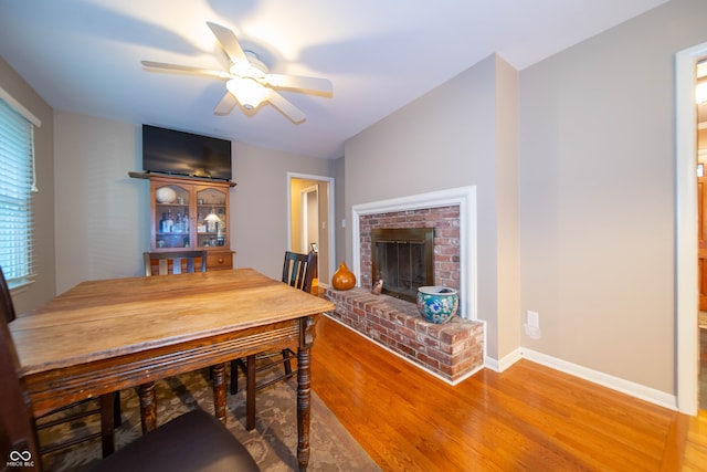 7224 N Tuxedo St, Indianapolis, IN 46240 - dining area with wood finished floors, ceiling fan, and a brick fireplace