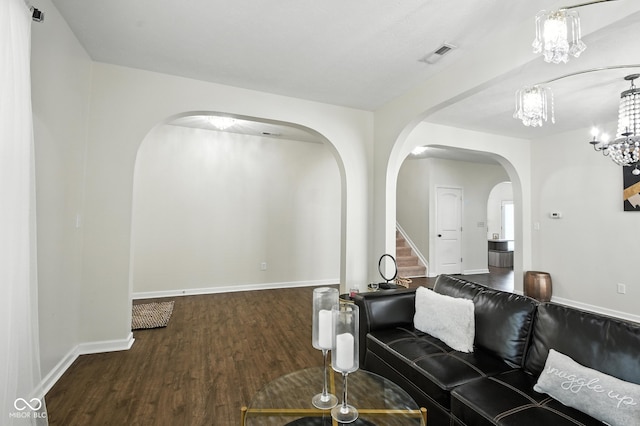 5664 Crump Ln, Indianapolis, IN 46234 - living room with arched walkways, wood finished floors, stairs, and a chandelier