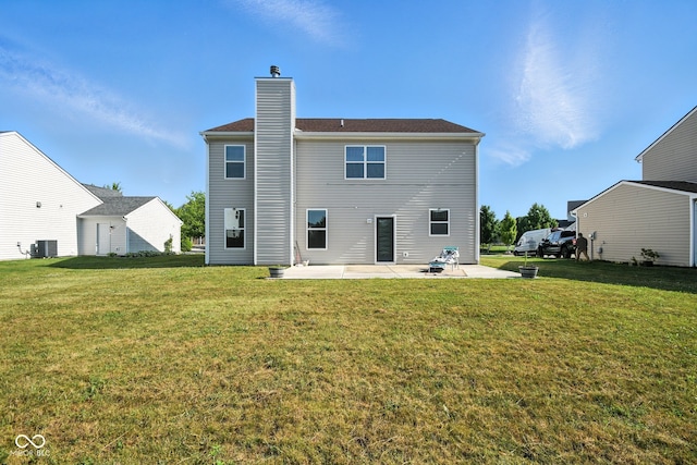 5664 Crump Ln, Indianapolis, IN 46234 - back of property with a patio area, a yard, and a chimney