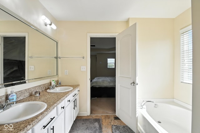 5664 Crump Ln, Indianapolis, IN 46234 - ensuite bathroom featuring double vanity, a garden tub, stone finish floors, and plenty of natural light