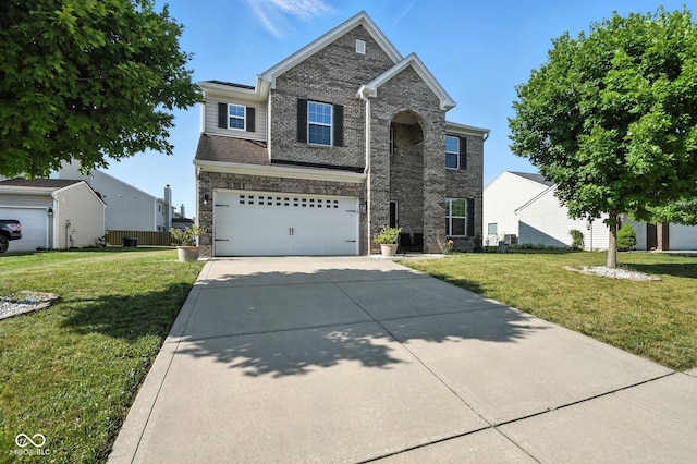5664 Crump Ln, Indianapolis, IN 46234 - traditional-style home featuring concrete driveway, a front lawn, a garage, and brick siding
