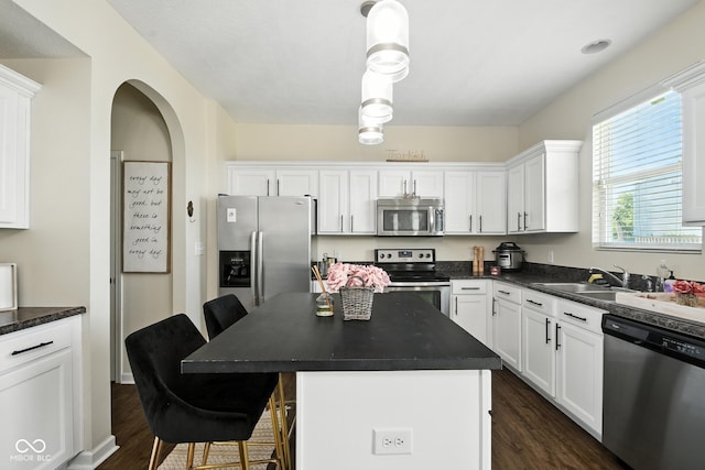 5664 Crump Ln, Indianapolis, IN 46234 - kitchen with appliances with stainless steel finishes, dark wood-style floors, white cabinetry, and dark countertops