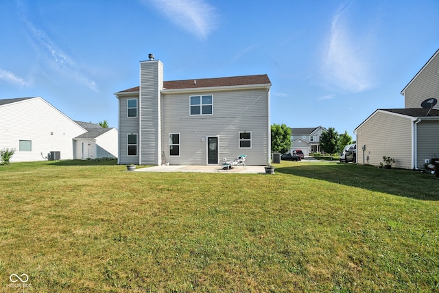 5664 Crump Ln, Indianapolis, IN 46234 - back of property with a patio, a yard, and a chimney