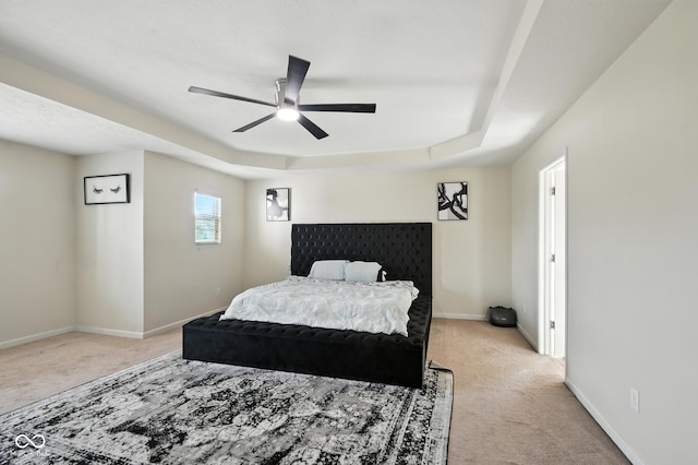 5664 Crump Ln, Indianapolis, IN 46234 - bedroom with light carpet, a ceiling fan, and a tray ceiling