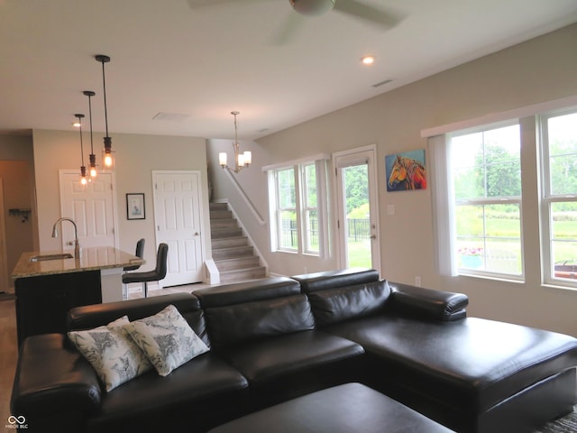 2272 Trefoil Dr, Plainfield, IN 46168 - living room featuring stairway, a ceiling fan, dark wood-style floors, a chandelier, and recessed lighting