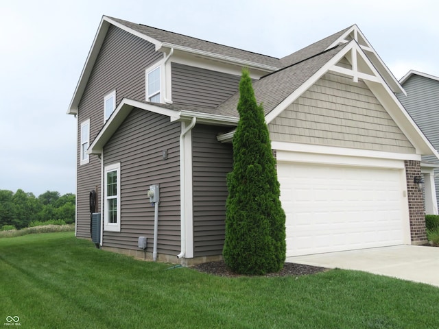 2272 Trefoil Dr, Plainfield, IN 46168 - view of side of property with concrete driveway, a garage, a lawn, and roof with shingles