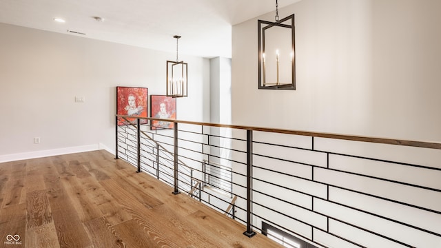 12022 Otto Ln, Carmel, IN 46032 - hall with wood finished floors and a chandelier
