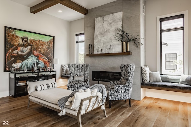 12022 Otto Ln, Carmel, IN 46032 - living area featuring wood finished floors, plenty of natural light, beam ceiling, and recessed lighting
