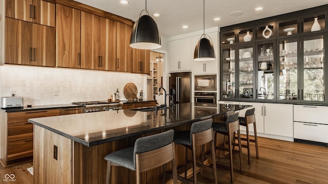 12022 Otto Ln, Carmel, IN 46032 - kitchen with oven, high quality fridge, built in microwave, brown cabinetry, and backsplash