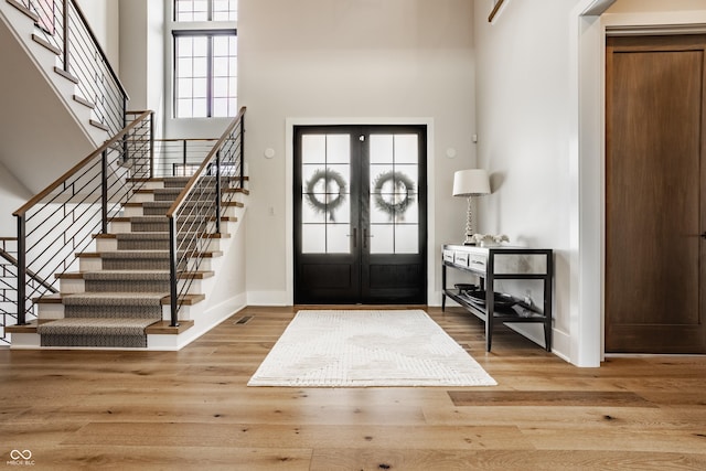 12022 Otto Ln, Carmel, IN 46032 - foyer with french doors, stairs, wood finished floors, and a towering ceiling