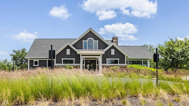 12022 Otto Ln, Carmel, IN 46032 - rear view of house with board and batten siding, a chimney, and roof with shingles