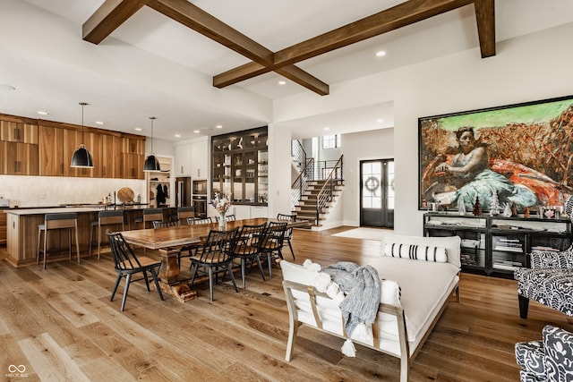 12022 Otto Ln, Carmel, IN 46032 - dining space featuring recessed lighting, beam ceiling, light wood-style floors, and stairs