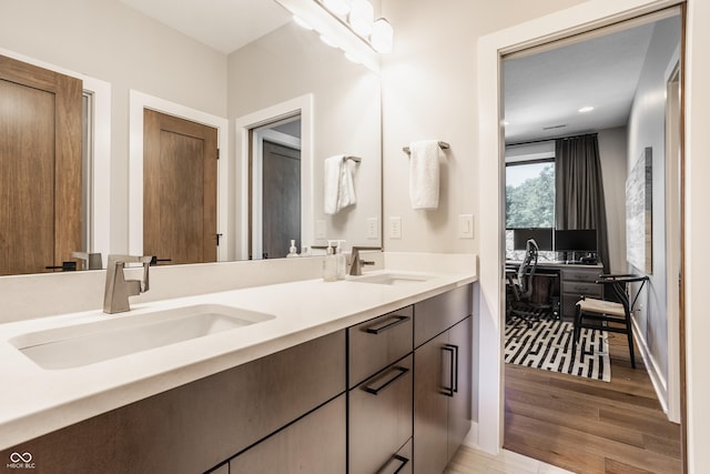 12022 Otto Ln, Carmel, IN 46032 - bathroom featuring double vanity, wood finished floors, and recessed lighting