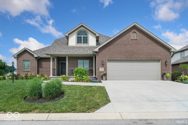 4909 N Graystone Dr, Muncie, IN 47304 - traditional-style home with brick siding, a garage, concrete driveway, and a front yard