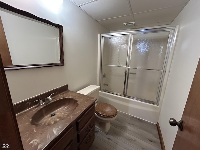 4675 N Riverside Dr, Columbus, IN 47203 - full bath with vanity, wood finished floors, a paneled ceiling, and shower / bath combination with glass door
