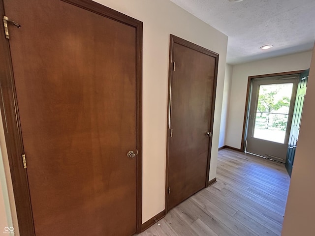 4675 N Riverside Dr, Columbus, IN 47203 - hall featuring light wood-style flooring, a textured ceiling, and recessed lighting
