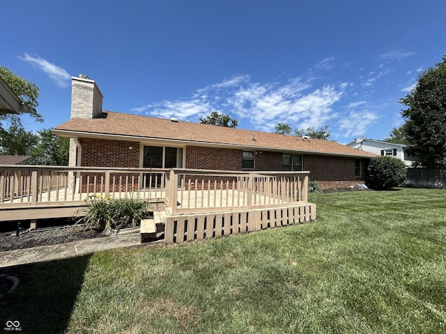 4675 N Riverside Dr, Columbus, IN 47203 - back of property featuring brick siding, a chimney, a yard, and a wooden deck