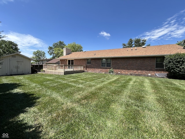 4675 N Riverside Dr, Columbus, IN 47203 - rear view of property featuring brick siding, a shed, a lawn, and a chimney