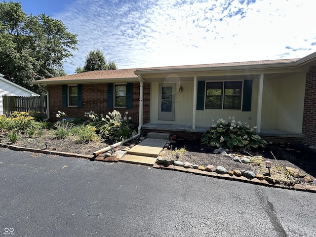 4675 N Riverside Dr, Columbus, IN 47203 - ranch-style home featuring covered porch and brick siding