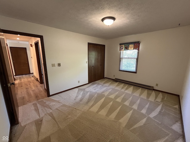 4675 N Riverside Dr, Columbus, IN 47203 - unfurnished room with a baseboard heating unit, light carpet, and a textured ceiling