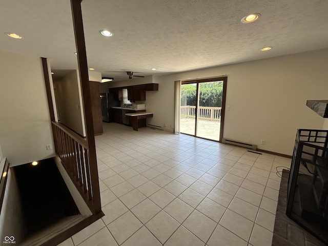 4675 N Riverside Dr, Columbus, IN 47203 - unfurnished living room with baseboard heating, ceiling fan, recessed lighting, light tile patterned flooring, and a textured ceiling