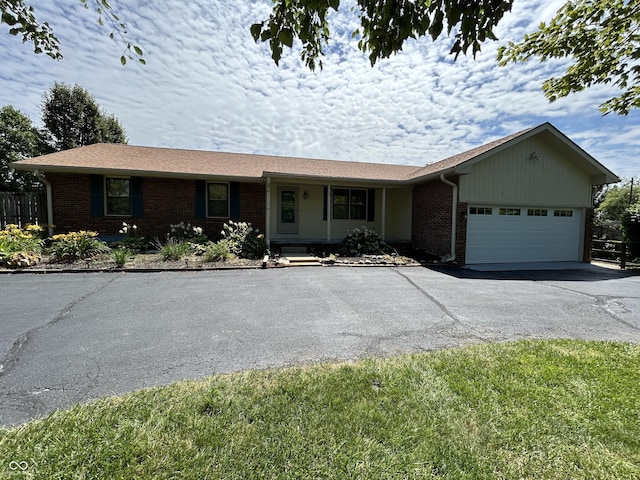 4675 N Riverside Dr, Columbus, IN 47203 - single story home with brick siding, driveway, and an attached garage