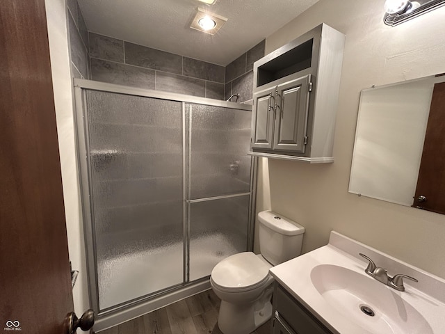 4675 N Riverside Dr, Columbus, IN 47203 - bathroom featuring vanity, wood finished floors, a shower stall, and a textured ceiling