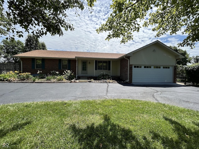 4675 N Riverside Dr, Columbus, IN 47203 - ranch-style house featuring brick siding, driveway, and a garage