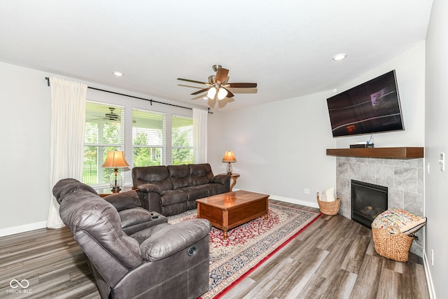 16502 Dominion Dr, Fishers, IN 46040 - living room with ceiling fan, wood finished floors, a tile fireplace, and recessed lighting