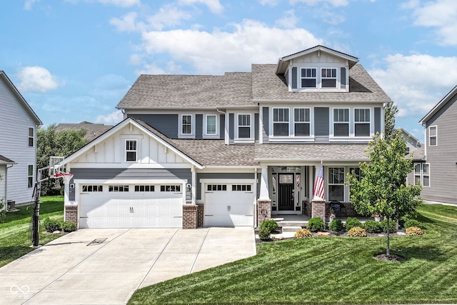 16502 Dominion Dr, Fishers, IN 46040 - view of front facade featuring concrete driveway, roof with shingles, board and batten siding, a front lawn, and brick siding