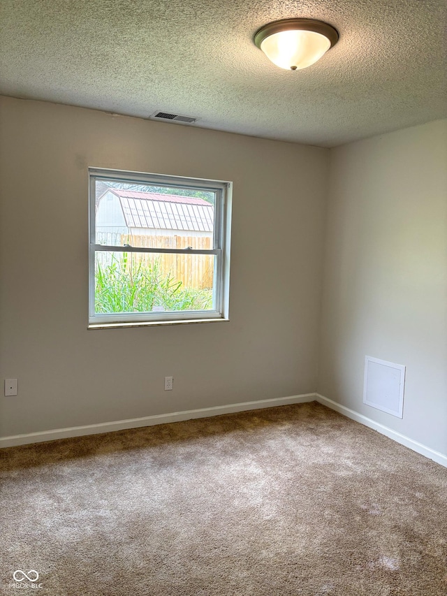 2770 Two Worlds Dr, Columbus, IN 47201 - carpeted empty room featuring a textured ceiling and baseboards