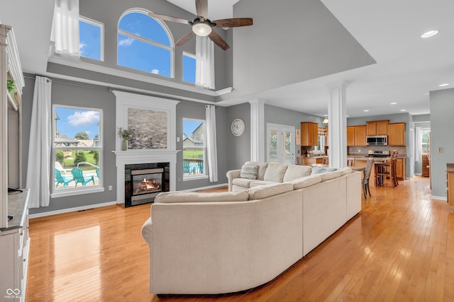 7830 Cross Crk, Avon, IN 46123 - living room with a ceiling fan, a premium fireplace, light wood-style floors, ornate columns, and recessed lighting