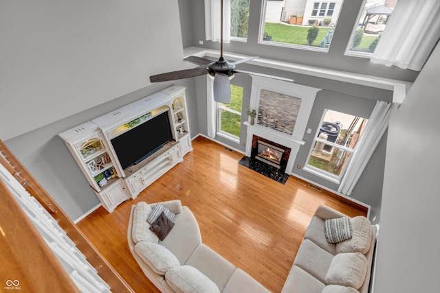 7830 Cross Crk, Avon, IN 46123 - living area featuring a towering ceiling, a high end fireplace, light wood-type flooring, and ceiling fan