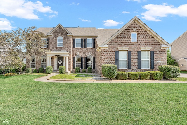 7830 Cross Crk, Avon, IN 46123 - colonial-style house with brick siding, a front yard, and a shingled roof