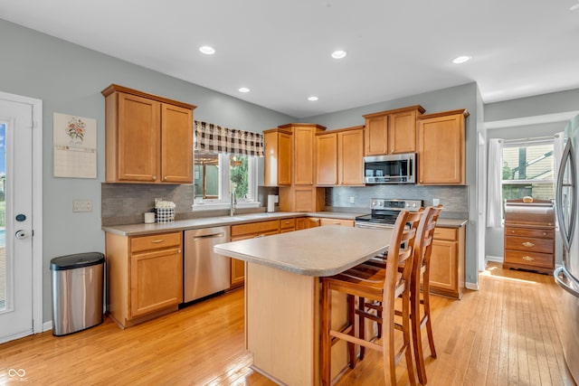 7830 Cross Crk, Avon, IN 46123 - kitchen featuring stainless steel appliances, light countertops, light wood-type flooring, backsplash, and recessed lighting