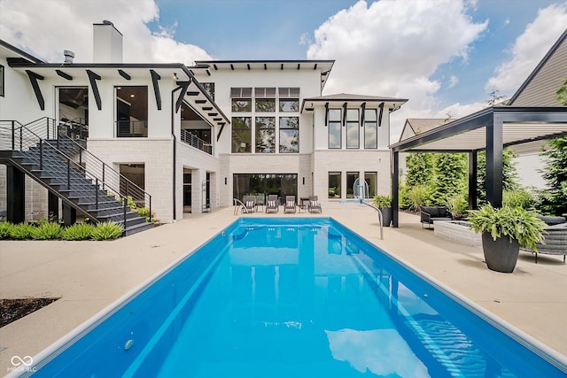 1269 Chatham Rdg Ct, Westfield, IN 46074 - back of property with a patio area, an outdoor pool, a balcony, and stucco siding