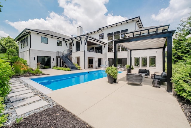1269 Chatham Rdg Ct, Westfield, IN 46074 - rear view of house featuring stairs, outdoor lounge area, a patio area, an outdoor pool, and a chimney