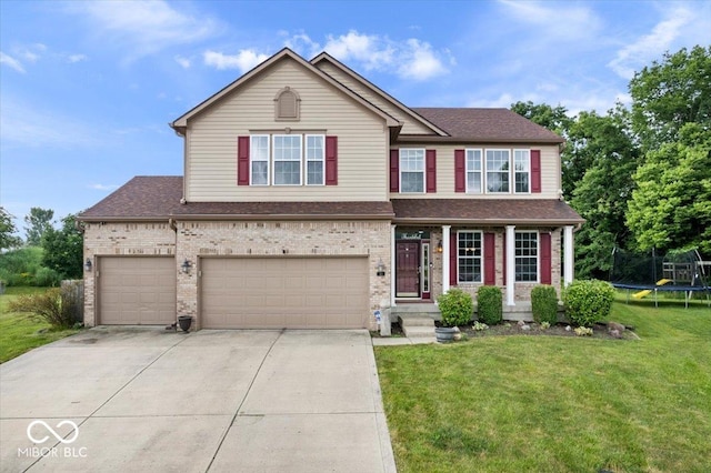 143 W Clear Lake Ct, Westfield, IN 46074 - view of front of house featuring concrete driveway, a trampoline, roof with shingles, and a front lawn