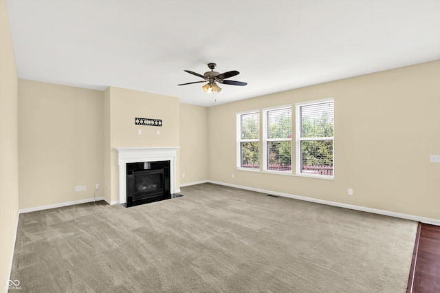 14095 Northcoat Pl, Fishers, IN 46038 - unfurnished living room with ceiling fan, a fireplace with flush hearth, and carpet flooring
