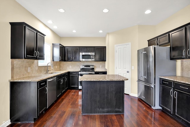 14095 Northcoat Pl, Fishers, IN 46038 - kitchen featuring appliances with stainless steel finishes, a kitchen island, dark wood-style flooring, dark cabinetry, and recessed lighting