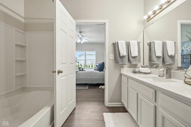12404 Titans Dr, Fishers, IN 46037 - ensuite bathroom featuring wood finished floors, vanity, a ceiling fan, and bathing tub / shower combination