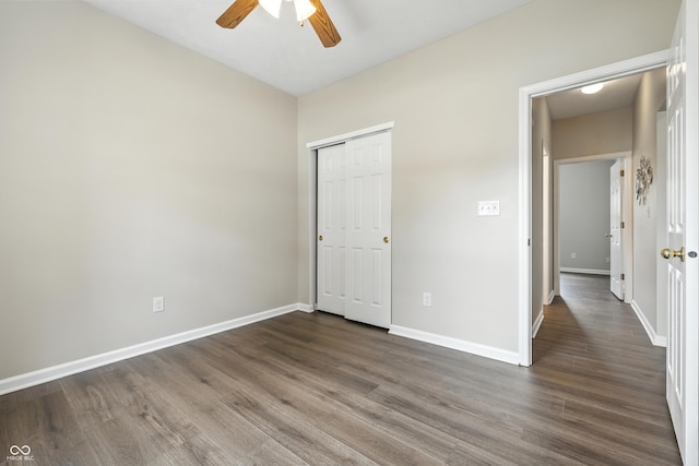 12404 Titans Dr, Fishers, IN 46037 - unfurnished bedroom with dark wood-style floors, a closet, and ceiling fan