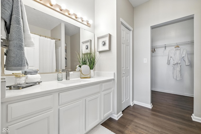 12404 Titans Dr, Fishers, IN 46037 - full bathroom featuring vanity, wood finished floors, and a walk in closet