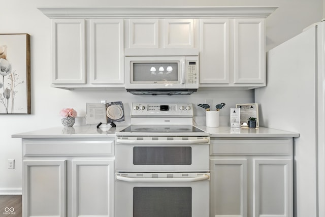 12404 Titans Dr, Fishers, IN 46037 - kitchen featuring white appliances, light countertops, and white cabinetry