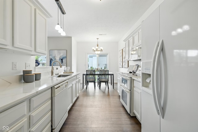 12404 Titans Dr, Fishers, IN 46037 - kitchen featuring white appliances, dark wood finished floors, a chandelier, and plenty of natural light