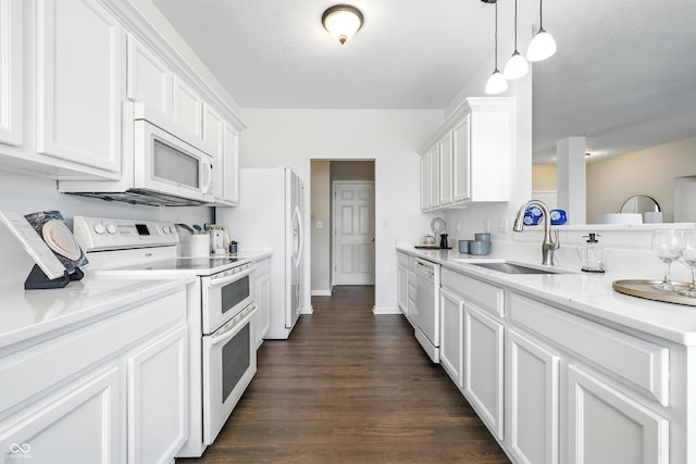 12404 Titans Dr, Fishers, IN 46037 - kitchen featuring white appliances, white cabinets, dark wood-type flooring, and light countertops
