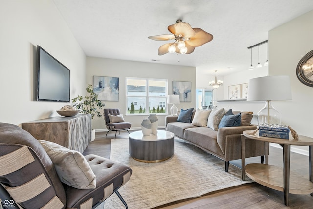 12404 Titans Dr, Fishers, IN 46037 - living area with wood finished floors, a chandelier, and a ceiling fan
