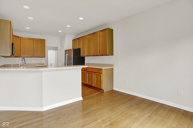 16130 Matlock Cir, Westfield, IN 46074 - kitchen with appliances with stainless steel finishes, light wood finished floors, light countertops, recessed lighting, and a peninsula
