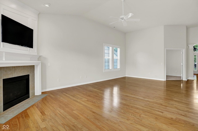 16130 Matlock Cir, Westfield, IN 46074 - unfurnished living room with light wood finished floors, ceiling fan, lofted ceiling, and a tiled fireplace